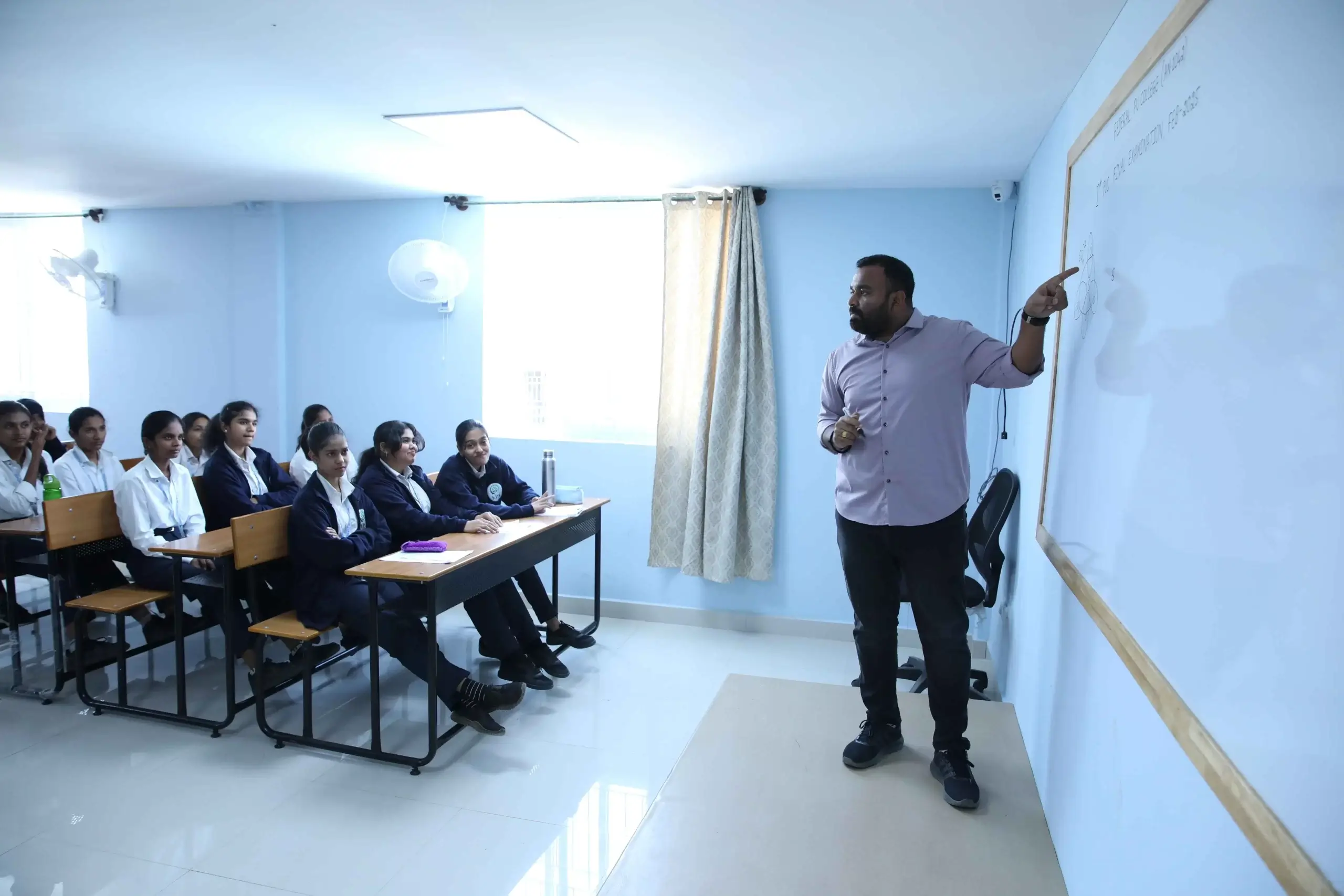 Experienced faculty teaching an interactive lesson at the best Integrated PU College in Bangalore